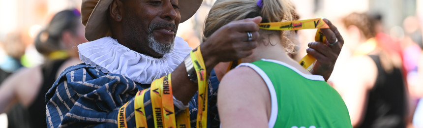 volunteer handing out medal