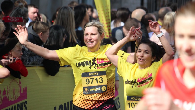 Two runners wearing the official London Landmarks Half Marathon technical T-shirt