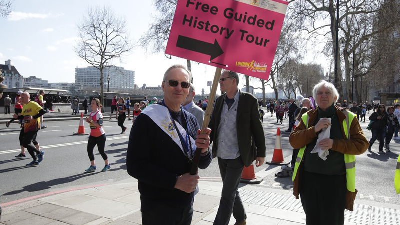 Tour guide holding placard