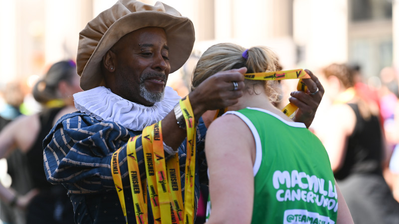 Volunteer handing out medal